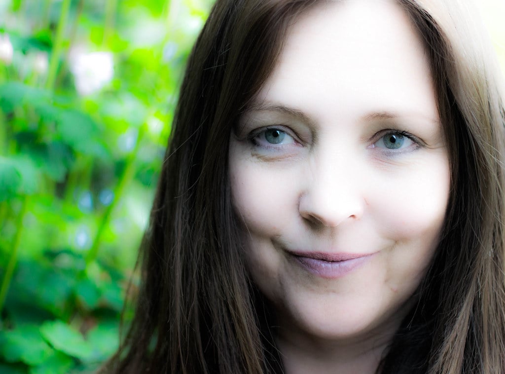 Close up photo of optimistic young woman